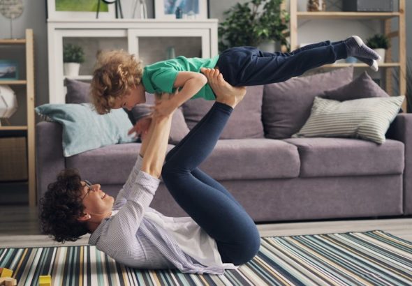 a woman and a child playing on the floor